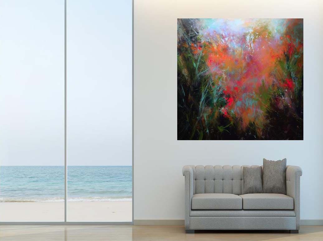 A couch and painting in a room with a window overlooking the ocean.