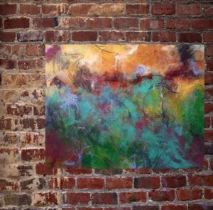 A painting of a field on the side of a brick wall.