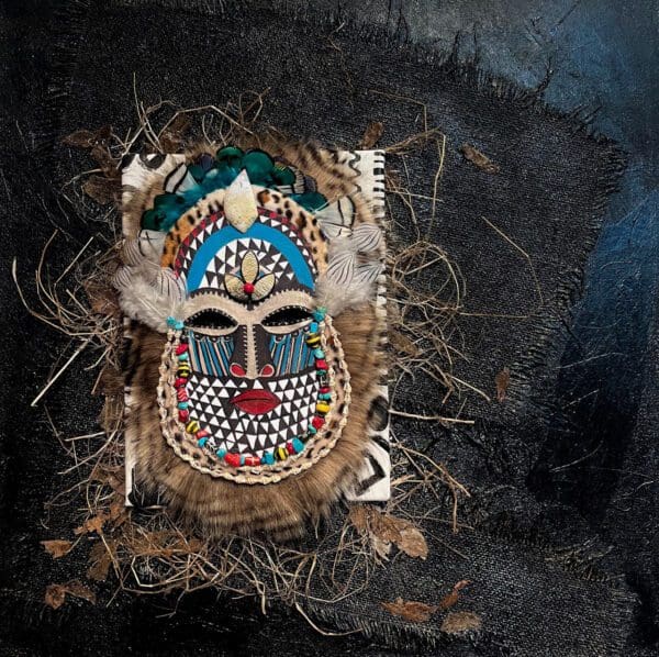 A close up of an african mask with feathers